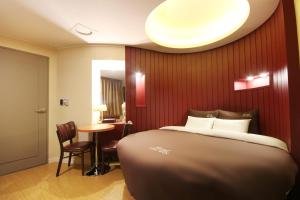 Postel nebo postele na pokoji v ubytování Hotel Chowon