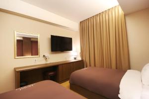 Postel nebo postele na pokoji v ubytování Hotel Chowon