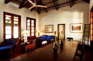 a living room filled with furniture and a large window at Pinctada McAlpine House in Broome