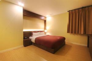 Postel nebo postele na pokoji v ubytování Hotel Chowon