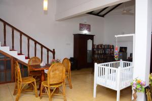 a dining room with a table and chairs at Kabalana Design House Villa in Ahangama
