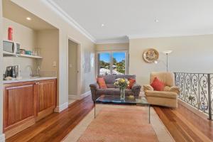 a living room with a couch and a table at Sorrento Beach Bed & Breakfast in Perth