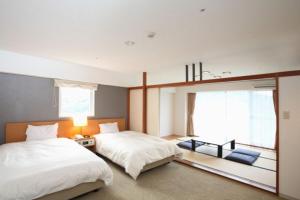 เตียงในห้องที่ Wisterian Life Club Usami