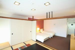 เตียงในห้องที่ Wisterian Life Club Usami