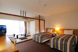 เตียงในห้องที่ Wisterian Life Club Usami