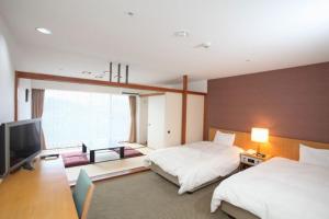 เตียงในห้องที่ Wisterian Life Club Usami