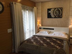 เตียงในห้องที่ Beautiful Apartments at Tarudhan Valley Golf Resort, Manesar