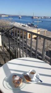 a table with a plate of food and a cup of coffee at Garibaldi R&B in Messina