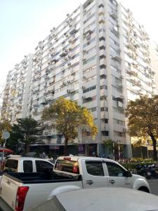 a white truck parked in front of a large building at Nesto Condo at Muangthong in Pak Kret