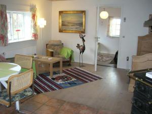 a living room with a table and a couch at Vranum Guesthouse in Viborg