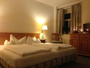 a bedroom with a large white bed and a window at Landhaus Lockwitzgrund in Lockwitz