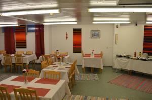 a dining room with white tables and chairs and tablesearcher at Economy Hotel Savonia in Kuopio