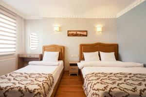 a hotel room with two beds in a room at Authentic Apartments OldCity in Istanbul