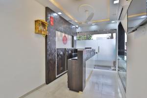 a lobby with a reception desk in a building at Nova Hotel Star Palace in Rajkot