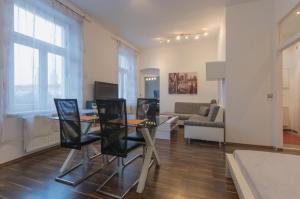 a living room with a table and chairs and a couch at Spacious Apartment in Center with Terrace in Vienna