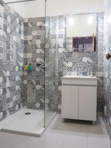 a bathroom with a shower and a sink at Bela House in Lagos