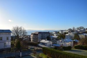 a city with houses and the ocean in the background at Villa Margarete in Sassnitz