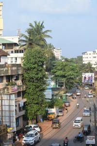 a tree covered in bananas on a city street at Falnir Palace in Mangalore