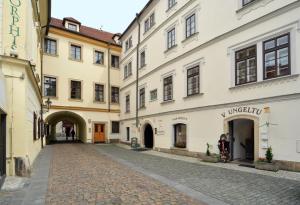 an empty street in a city with buildings at Hotel Metamorphis in Prague