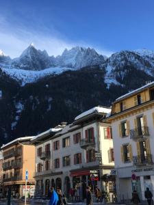 a group of buildings in front of a mountain at Appartement Alexandra in Chamonix