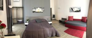 a living room with a bed and a couch at La Dimora di Garibaldi in Naples