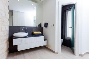 a bathroom with a sink and a mirror at Villa Soleil in Vela Luka