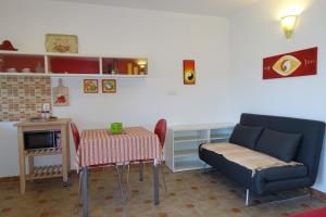 a living room with a couch and a table and a chair at Apartments Dalmatina in Zaton
