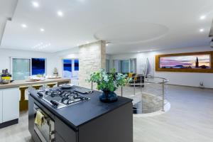 a kitchen and living room with a stove top oven at Villa Soleil in Vela Luka