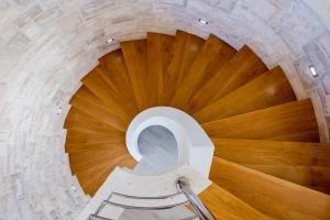 a wooden spiral staircase with a wooden floor at Villa Soleil in Vela Luka