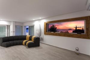 a living room with a couch and a painting on the wall at Villa Soleil in Vela Luka