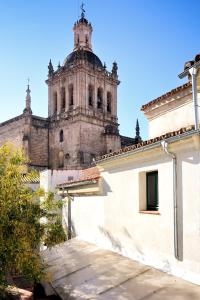 an old building with a tower in the background at Hotel Ahc Palacio Coria in Coria