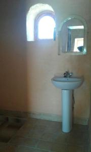 a bathroom with a sink and a mirror at Tazoult Ouzina in Ouzina