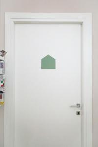 a white door with a green square on it at B&B Casetta Roma in Rome