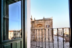 a view of a building from a window at Hotel Ahc Palacio Coria in Coria