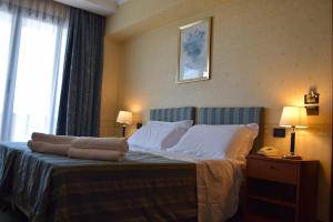 Postel nebo postele na pokoji v ubytování Hotel President Pomezia