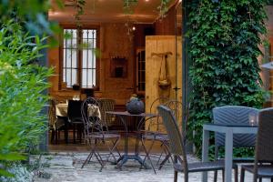 un patio con sillas y una mesa con un jarrón. en Maison d'Hôte de Myon en Nancy