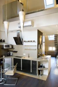 a kitchen with black and white cabinets and a table at Maison d'Hôte de Myon in Nancy +55 photos