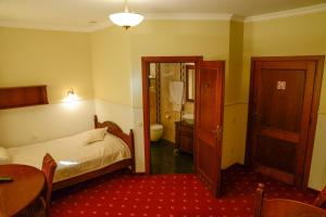 a hotel room with a bed and a bathroom at Revita in Józefów
