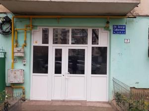 a white door of a building with a sign on it at Sector 6 - Metrou Gorjului - Studio G by MRG Apartments in Bucharest
