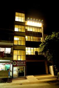 a tall building with lights on it at night at SGRT Residency in Vellore