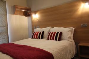 a bedroom with a large bed with two pillows at Townlets Serviced Accommodation Salisbury in Belfast