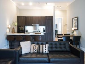 a living room with a couch and a kitchen at Park Central Executive in The Hague