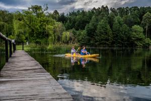 two people in a kayak on the water near a dock at Monte Video-Deo Gloria in Champagne Valley
