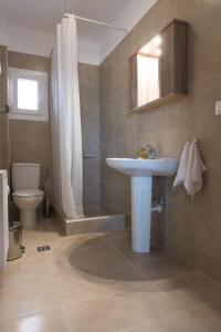 a bathroom with a sink and a toilet and a shower at House Okto in Alexandroupoli