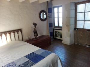 Schlafzimmer mit einem Bett und einem Wandspiegel in der Unterkunft La Motelle N 5 in Les Ulmes