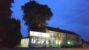 a building with a sign in front of it at night at Ferienhaus Congolo in Lontzen