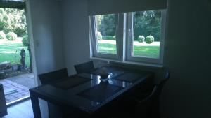 a table in a room with a window at Ferienhaus Congolo in Lontzen