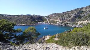 a boat in a large body of water at Dolphin Apartments in Faliraki