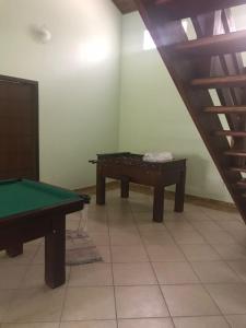 a room with a pool table and a table at Chacará com piscina climatizada 1 hora de SP Mogi das Cruzes,até 30 pessoas in Mogi das Cruzes