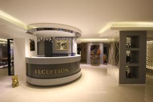 a fashion store with a sign that says reception at Ankara Gold Hotel in Ankara